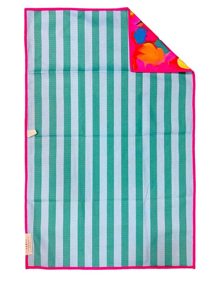 Striped blanket with green and white stripes and a colorful corner on a white background