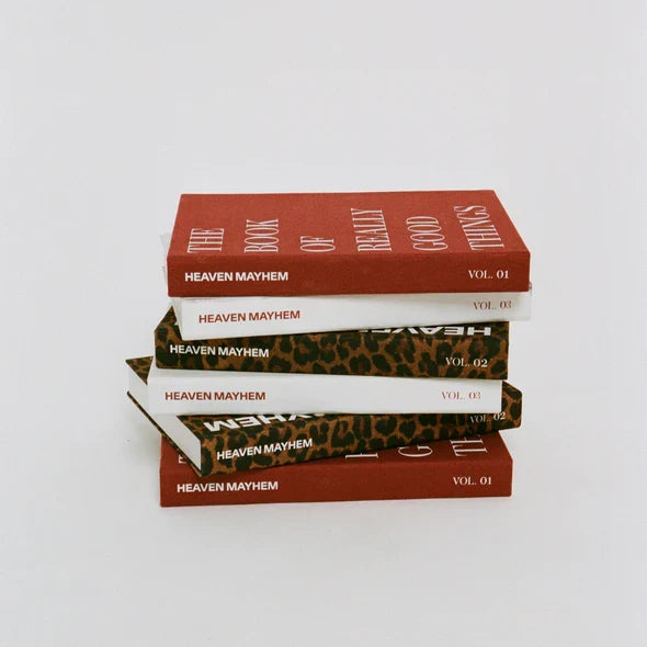 Stack of books titled 'Heaven Mayhem' on a white background