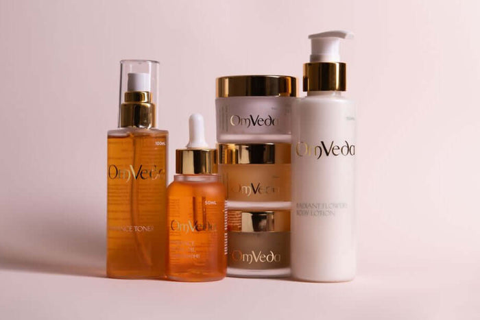 Radiance Kumkumadi skincare value bundle with amber serum bottle, jars, and pump bottles