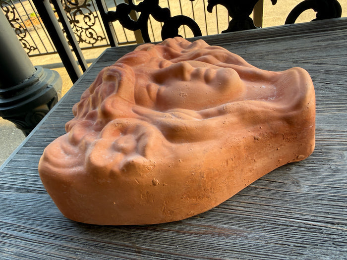Brown soap bar with a unique texture on a wooden surface