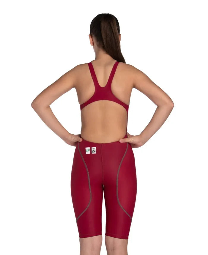 Arena Girls Powerskin ST Next kneesuit for girls in deep red, featuring a sleek, form-fitting design for swimming performance.