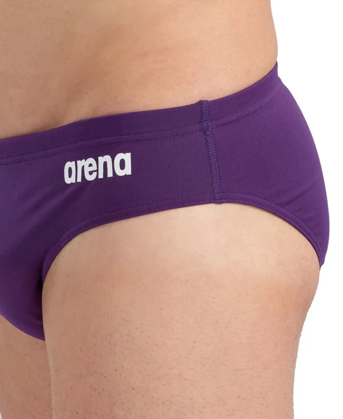 Arena men's solid team swim briefs in plum and white, featuring a snug fit and supportive design for competitive swimming.