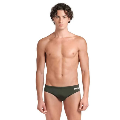 Arena men's team solid swim briefs in dark sage and white, featuring a snug fit and durable fabric for competitive swimming.