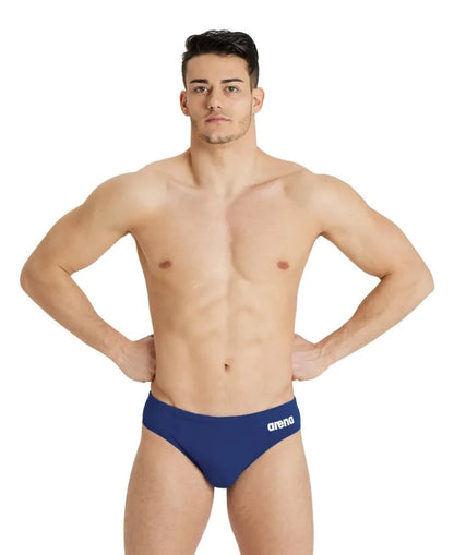 Navy blue Arena men's team swim briefs with a solid design, featuring a snug fit and comfortable waistband for swimming.