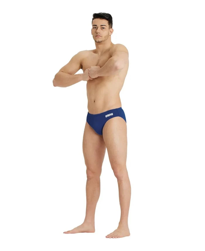 Navy blue Arena men's team swim briefs, solid design, form-fitting swimwear for competitive and training use.