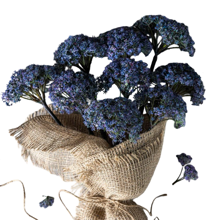 Bouquet of blue flowers wrapped in burlap on a white background