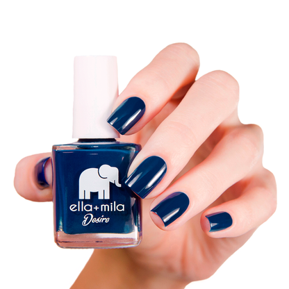 Blindfold Me navy blue nail polish manicure on a light skin tone with the bottle