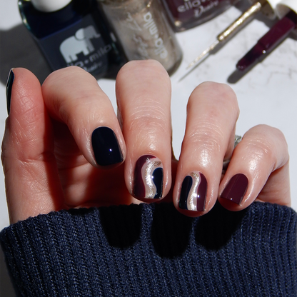 Blindfold Me deep navy nail polish manicure with a dark sweater