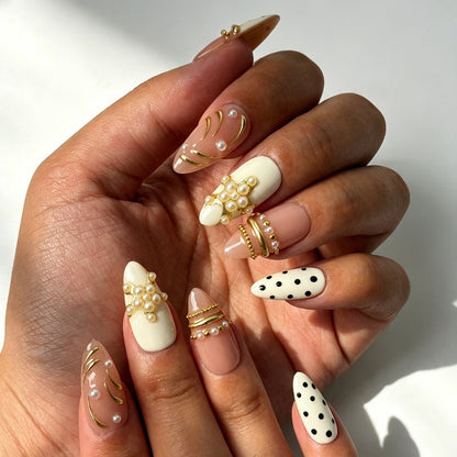 Elegant daily pearl polka dot fake nails close‑up hand shot