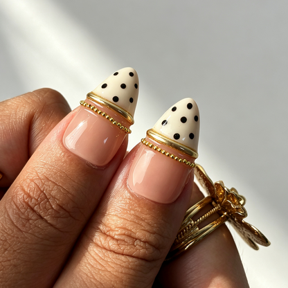 Elegant daily pearl polka dot fake nails close‑up hand shot
