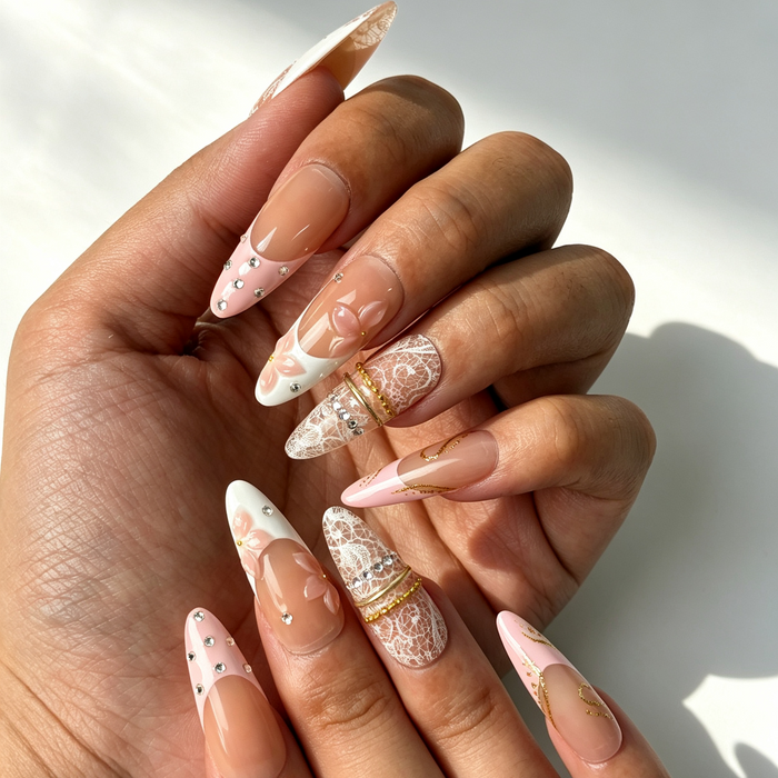 Close‑up handmade press‑on nails, white lace print pink sculpted flower gold chain manicure