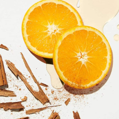 Fresh orange slices with cinnamon sticks and creamy sauce, vibrant citrus and spice on white background