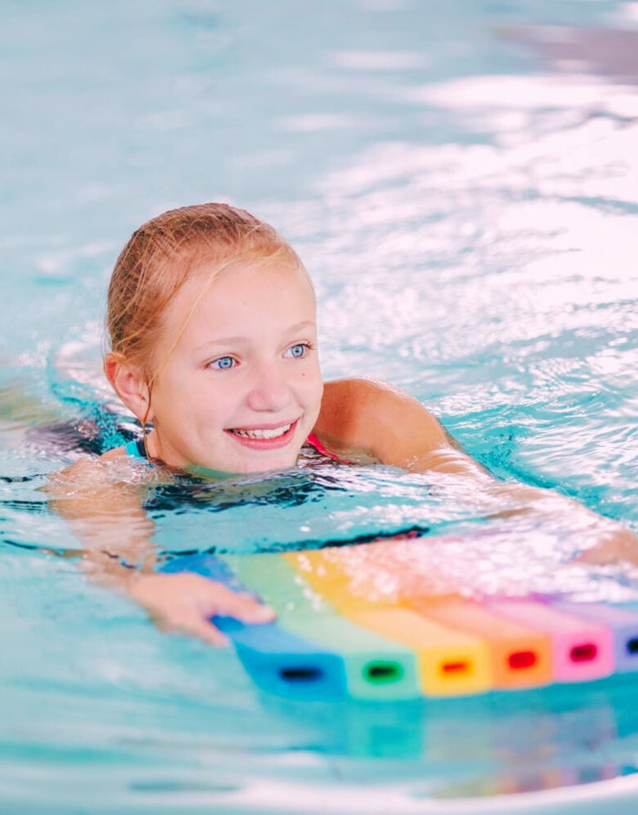Rainbow coloured Comfy Kickboard swim noodle with grip holes