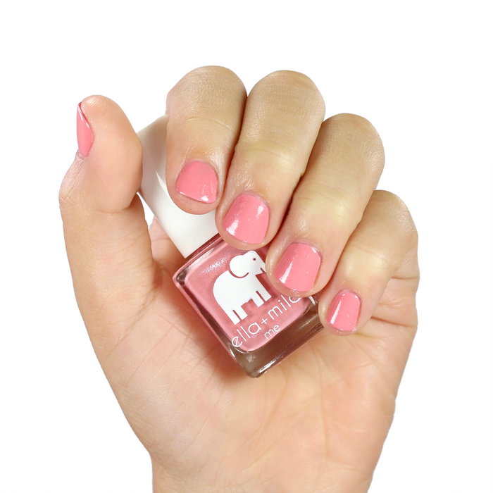 Cotton Candy peachy pink nail polish manicure on a medium skin tone with the bottle