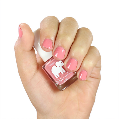 Cotton Candy peachy pink nail polish manicure on a medium skin tone with the bottle