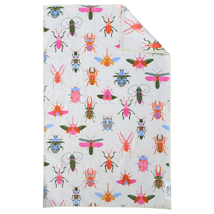 Folded fabric with colorful bug pattern on a white background