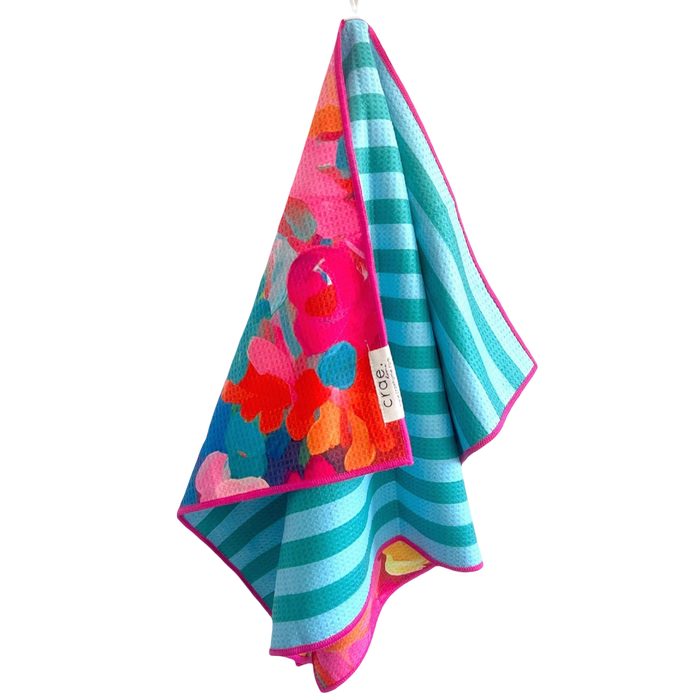 Colorful towel with floral pattern and stripes on a white background