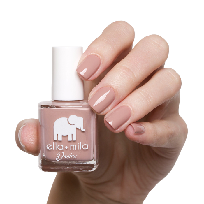 Desert Suede nude brown nail polish manicure on a light skin tone with the bottle