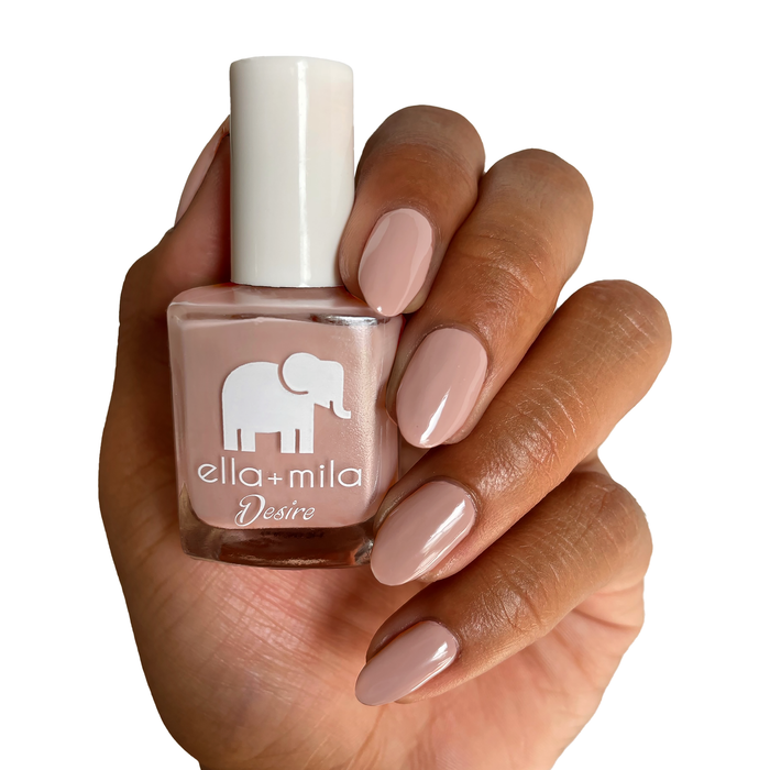 Desert Suede warm nude nail polish manicure on a medium skin tone with the bottle