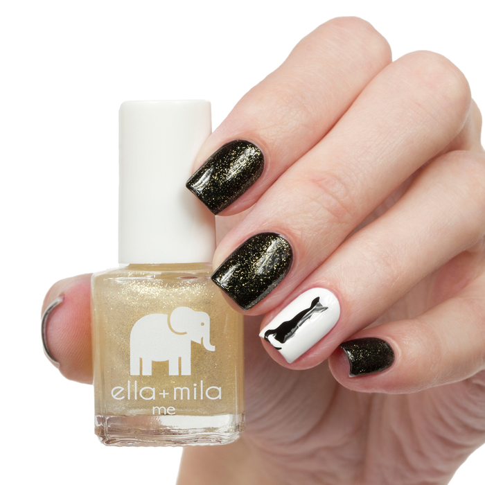 Dipped in Gold shimmer nail polish with black and white bow accent nail art