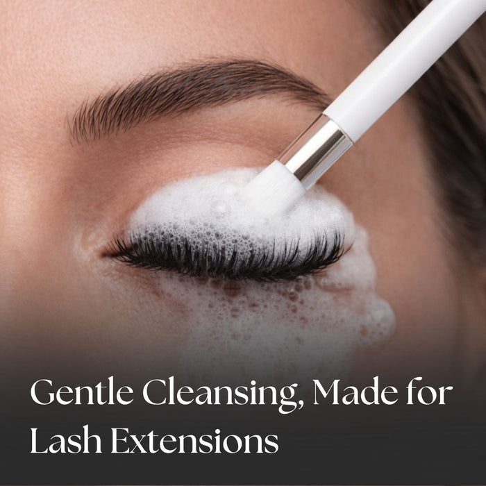 Person applying a lash cleanser to their eyelashes with a brush, text 'Gentle Cleansing, Made for Lash Extensions' below.