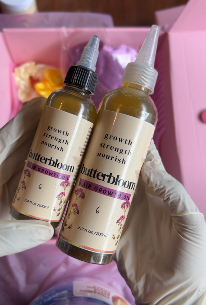 Bottle of butterbloom Hair Growth Oil infused with 21 herbs, showing the herbal blend and dropper applicator.
