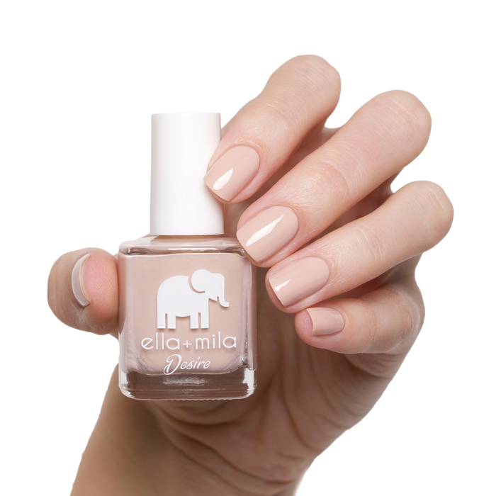 Light to the Touch neutral nude nail polish manicure on a light skin tone with the bottle