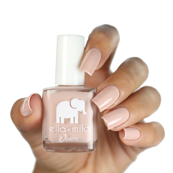 Light to the Touch light nude nail polish on a medium skin tone, hand holding the bottle