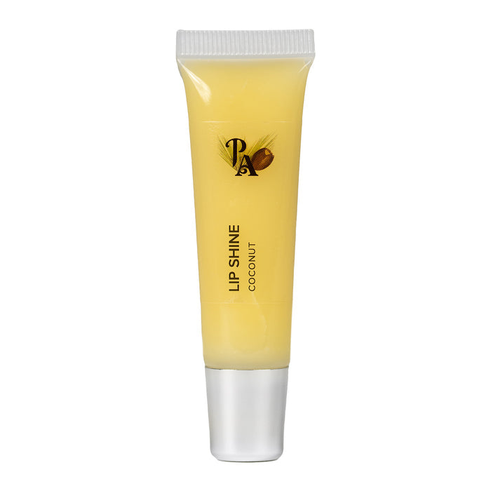 A tube of Pure Anada Lip Shine with a yellow tint, labeled 'LIP SHINE COCONUT', indicating a creamy coconut scent for the lip gloss.