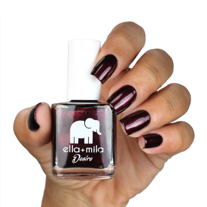 Lip Stain burgundy brown nail polish on a medium skin tone, hand holding the bottle