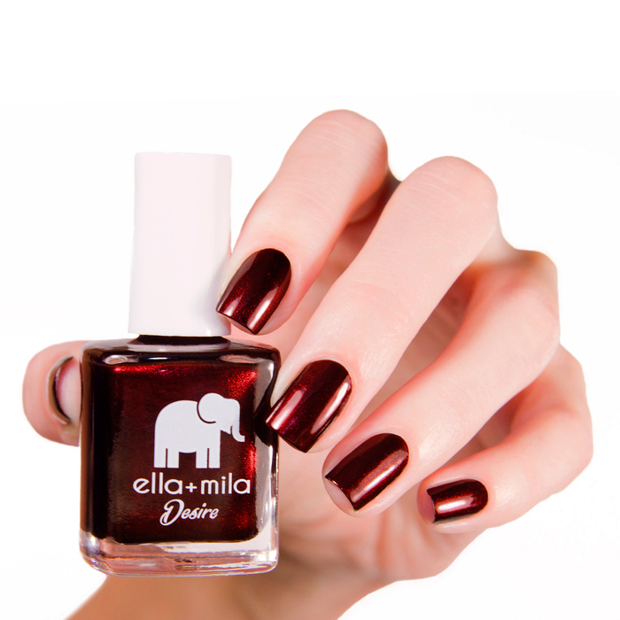 Lip Stain shimmery burgundy nail polish manicure on a light skin tone with the bottle