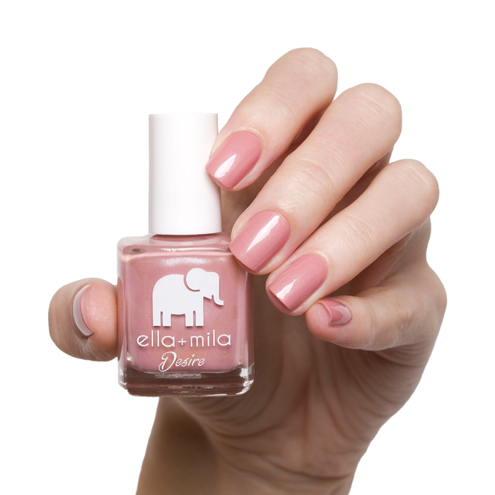 Luminous mauve pink shimmer nail polish manicure on a light skin tone with the bottle