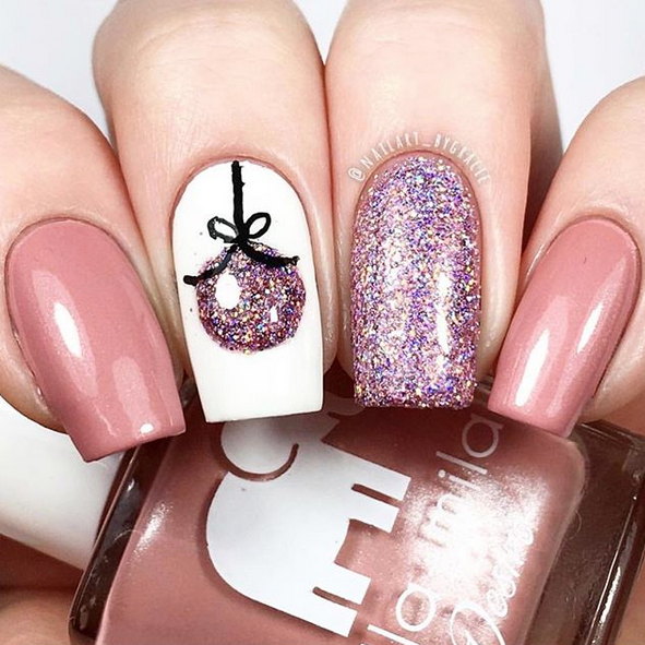 Luminous mauve pink nail polish with ornament and purple glitter accent nail art
