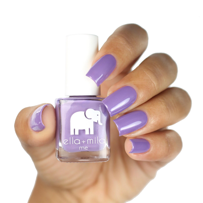 Mila's Fave light purple nail polish on a deep skin tone, hand holding the bottle