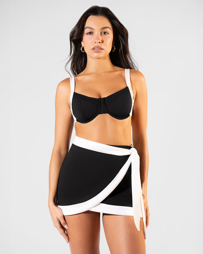 Model wearing Mini Wrap Skirty - Frame Black/White paired with Lifty Tie Back Bikini Top - Black White