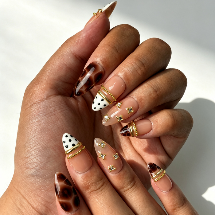 Vintage fall tortoise print press‑on nails close‑up hand shot