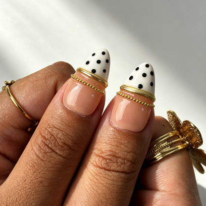 Nude base retro polka‑dot tortoise fake nails close‑up