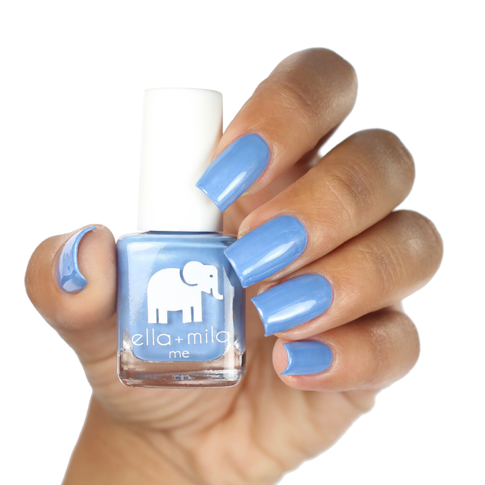 My Pool Party baby blue shimmer nail polish on a deep skin tone, hand holding the bottle