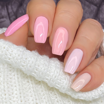 Ombre Collection pink gradient manicure from bright pink to pale pink on a light skin tone