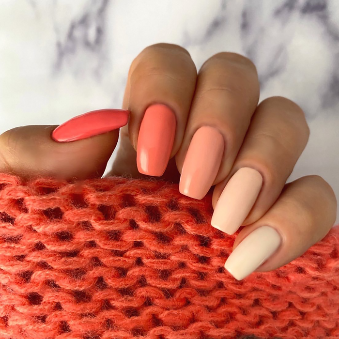 Ombre Collection coral gradient manicure from coral to peach to cream on a light skin tone