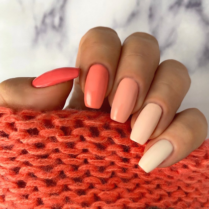 Ombre Collection coral gradient manicure from coral to peach to cream on a light skin tone
