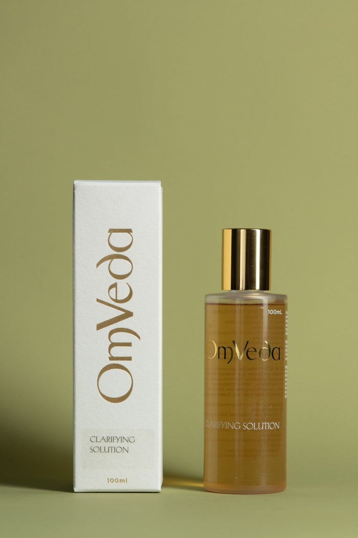 OmVeda clarifying solution 100ml: amber bottle with gold cap and white carton