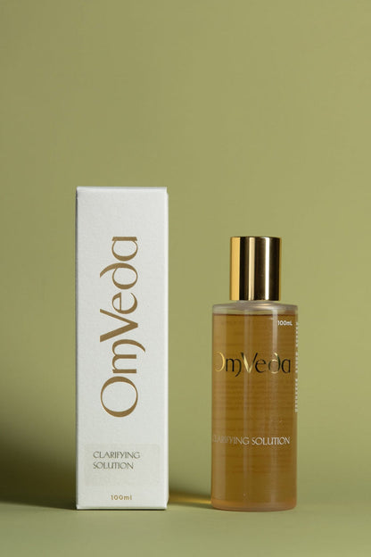 OmVeda clarifying solution 100ml: amber bottle with gold cap and white carton