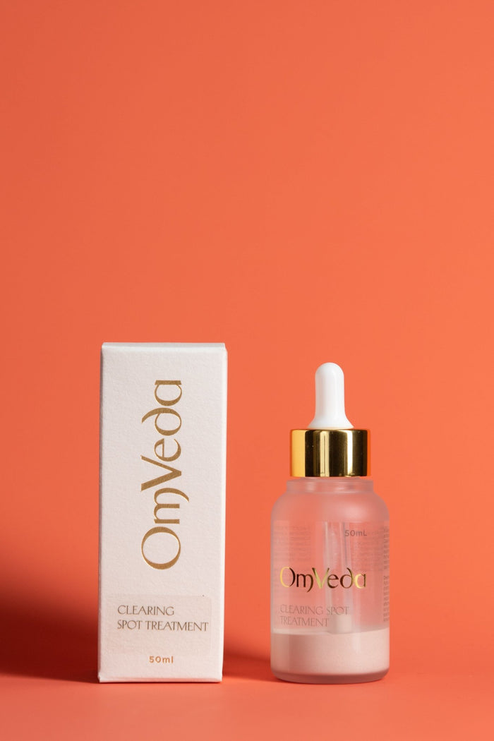 OmVeda clearing spot treatment set: box and 50ml dropper bottle, gold cap