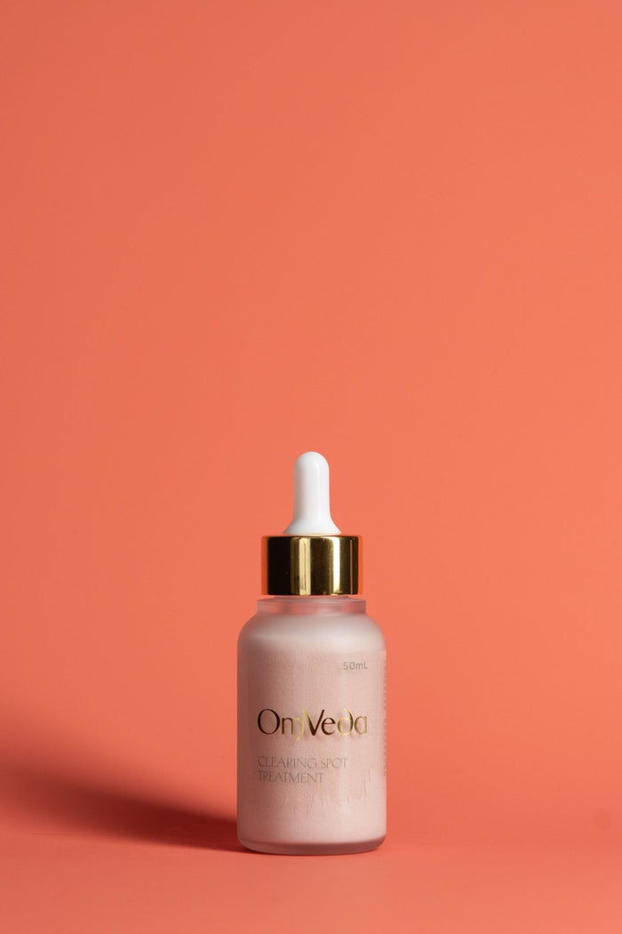 OmVeda clearing spot treatment dropper bottle with frosted pink serum
