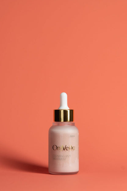 OmVeda clearing spot treatment dropper bottle with frosted pink serum