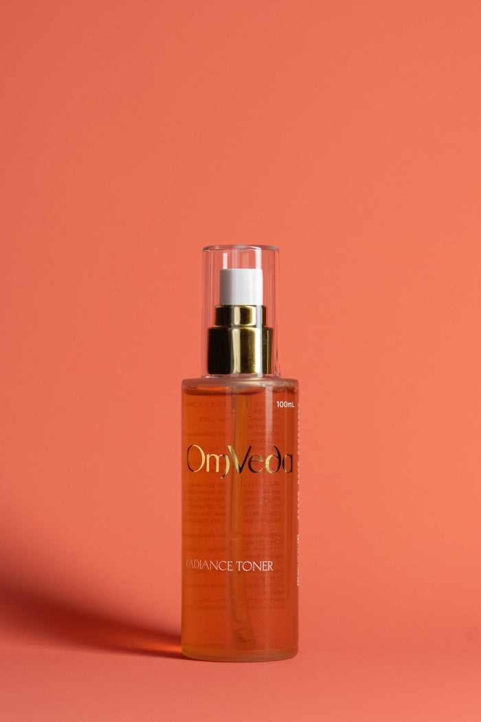 OmVeda Radiance Toner 100ml amber glass bottle with gold pump cap