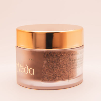 OmVeda 50ml exfoliant jar, close-up of textured product inside, gold lid.