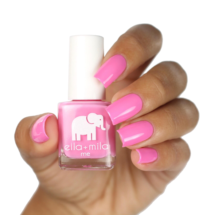 Pinkterest bubblegum pink nail polish on a deep skin tone, hand holding the bottle