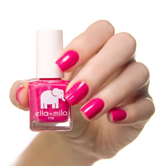 Pretty Princess sparkly hot pink nail polish on a medium skin tone, hand holding the bottle